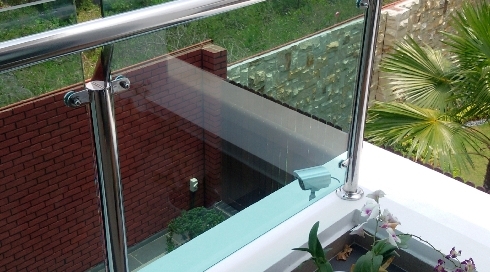 Balcony stainless steel with glass panel balustrade.